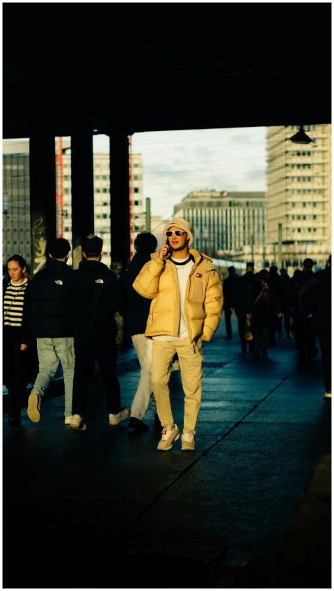 Stylish young adult in trendy clothing walking in