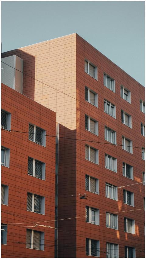 A contemporary red brick building with numerous wi