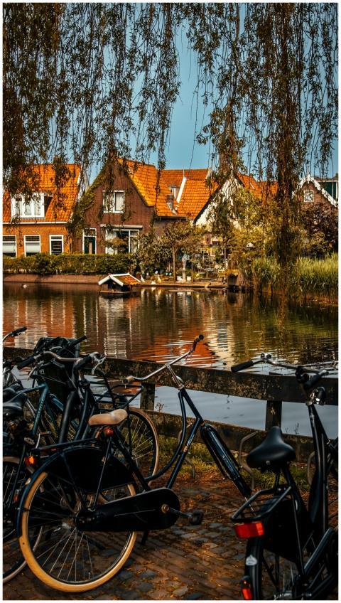 A beautiful view of Volendam with bicycles by a ca