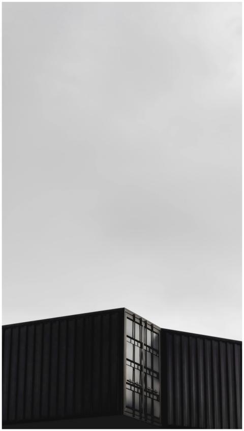 A sleek modern building with dark panels under an