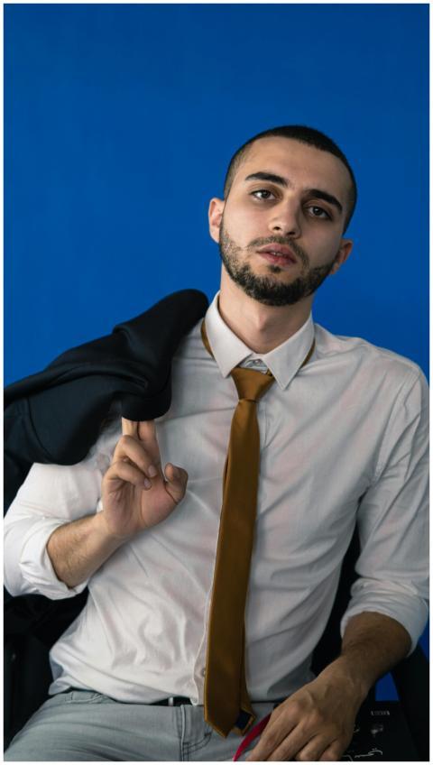 A confident young businessman adjusting his suit w