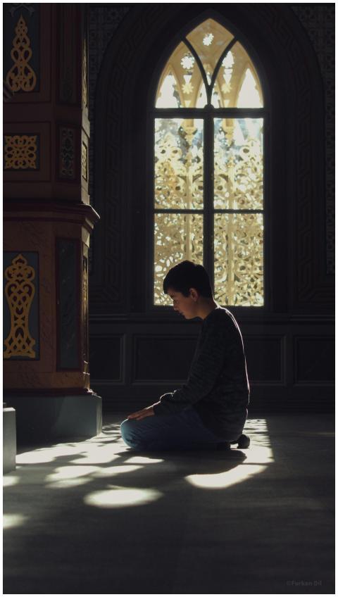 A child kneeling and praying inside a beautifully