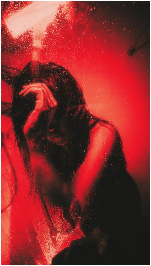 Artistic portrait of a person behind wet glass, il