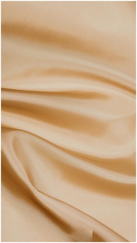 Close-up of smooth, beige silk fabric showcasing i
