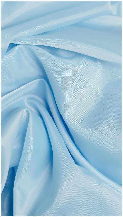 A detailed close-up of smooth and shiny blue silk