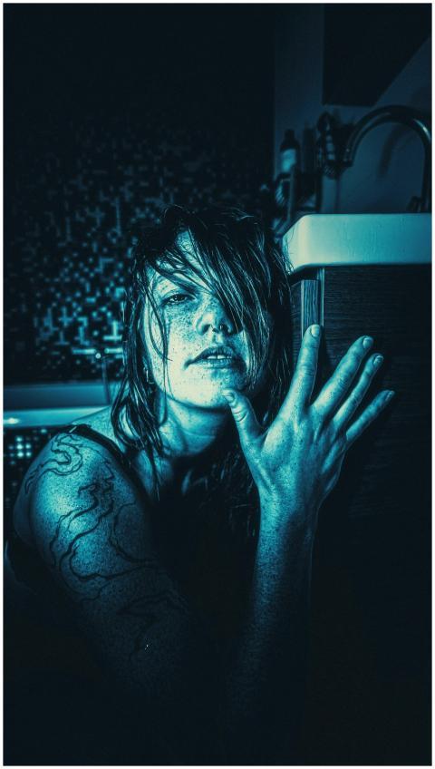 A dramatic and moody portrait of a woman with a da