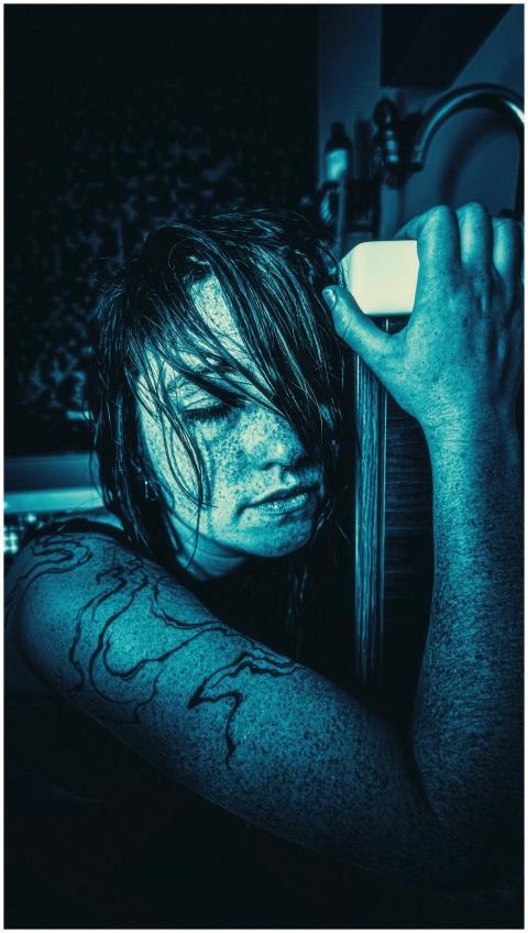 Artistic portrait of a woman with wet hair, dramat