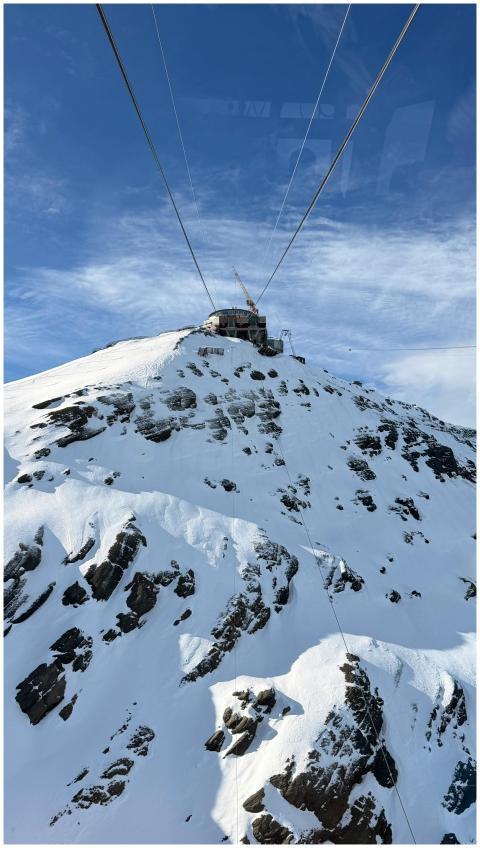 Stunning view of a snowy mountain peak from a cabl