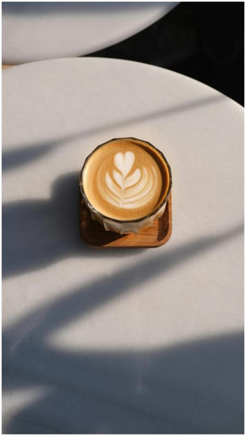 A cup of beautifully crafted latte art on a white