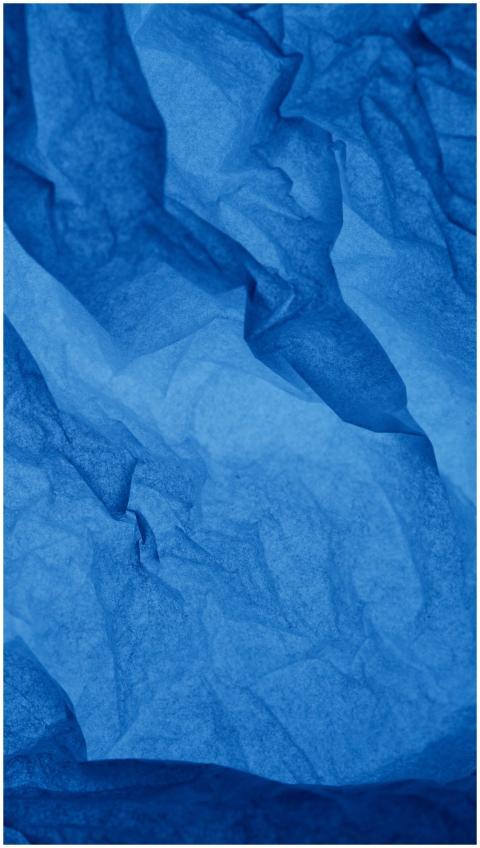Close-up of crumpled blue paper creating a texture