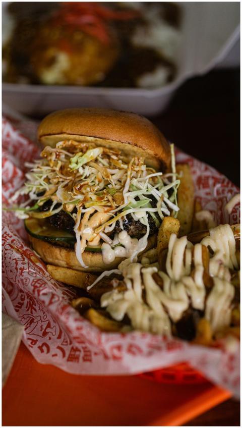 Delicious burger topped with coleslaw and cheese f