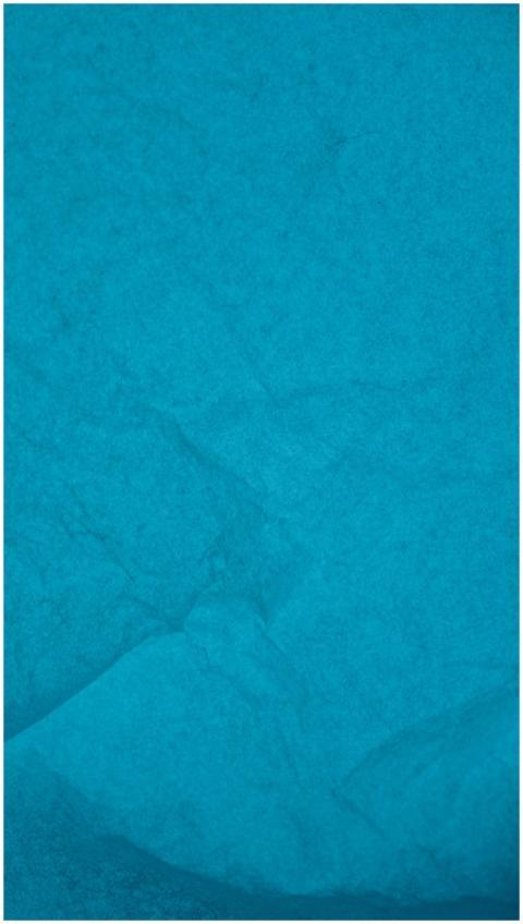A close-up shot of textured, wrinkled blue paper,