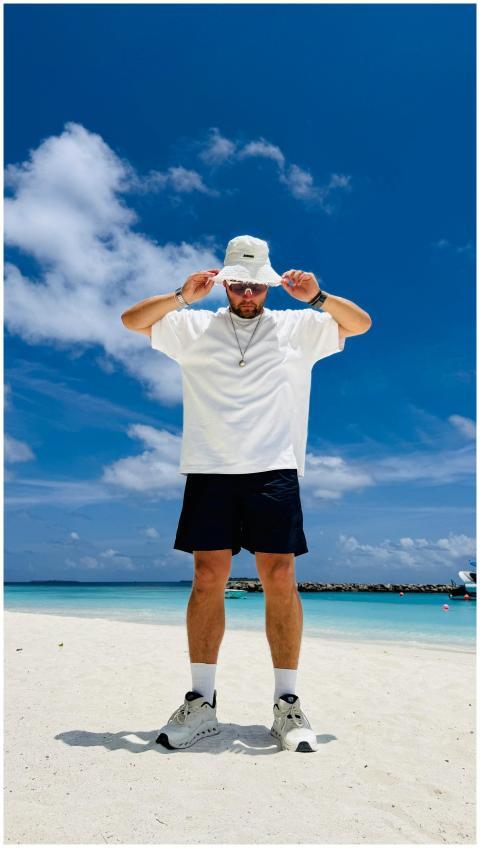 Casual man in summer attire on a pristine Maldives