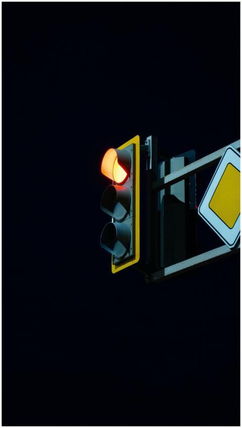 Traffic light showing a red stop signal at night a