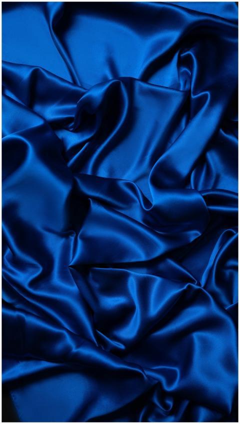 A smooth and rippled blue satin fabric creating a