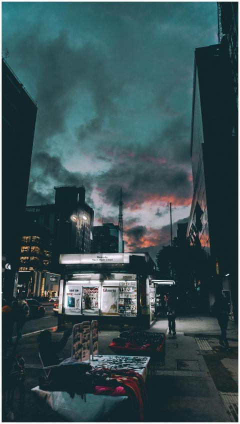 A dramatic twilight cityscape with illuminated cit