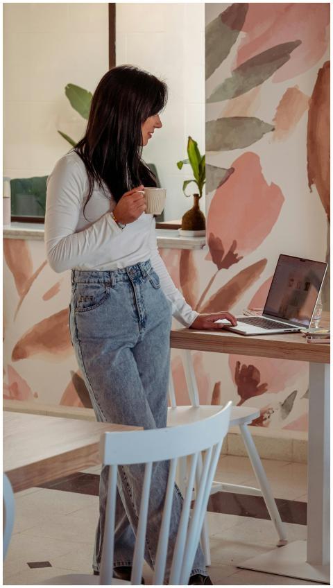 Casual home office scene with young woman standing