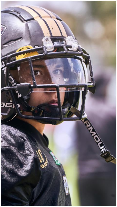 Close-up of a young football player in full protec