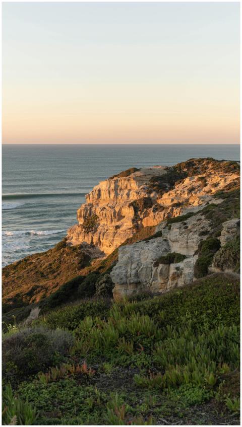 Serene view of sunset illuminating cliffs along th