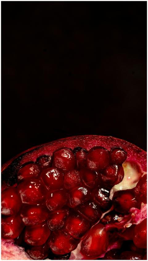 Vivid close-up of juicy red pomegranate seeds show