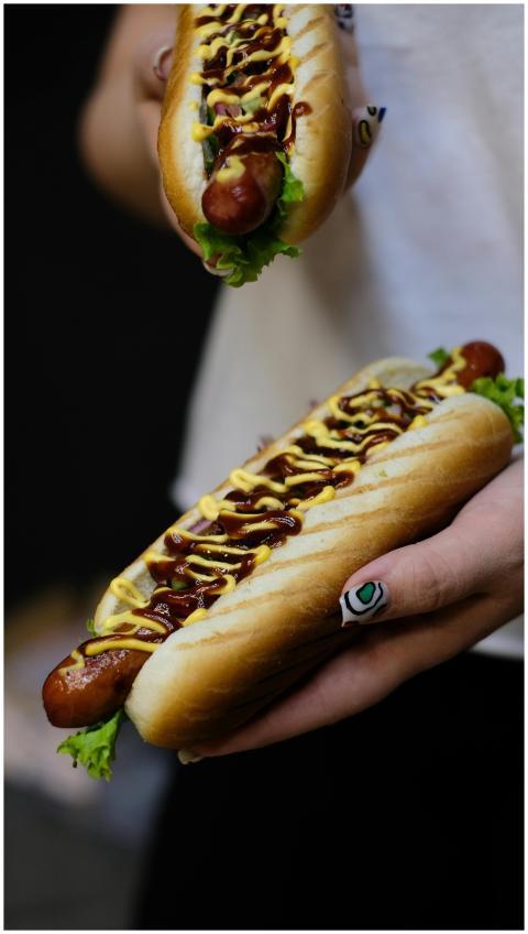 Close-up of tasty hot dogs with mustard and lettuc
