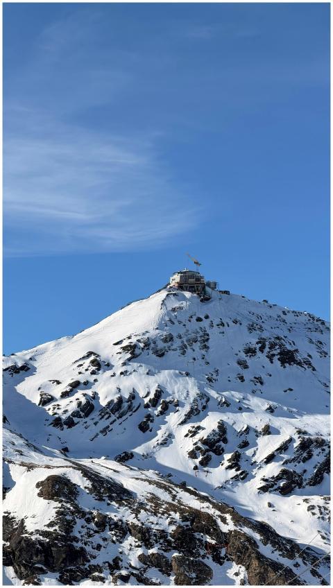 Scenic view of a snow-covered mountain peak with o