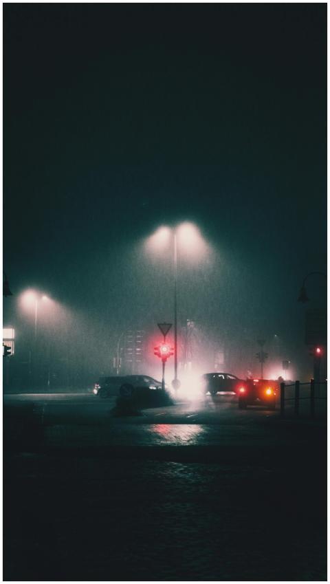 Atmospheric nighttime street scene with moving car