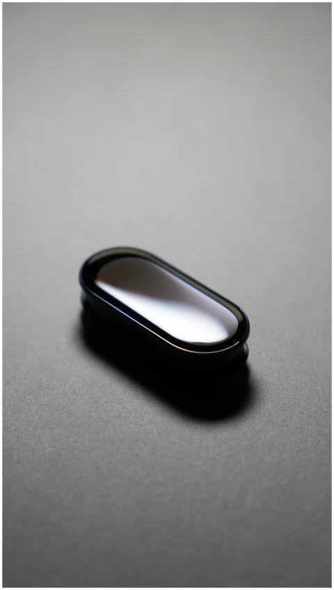 Minimalist sleek tech device on dark background, s