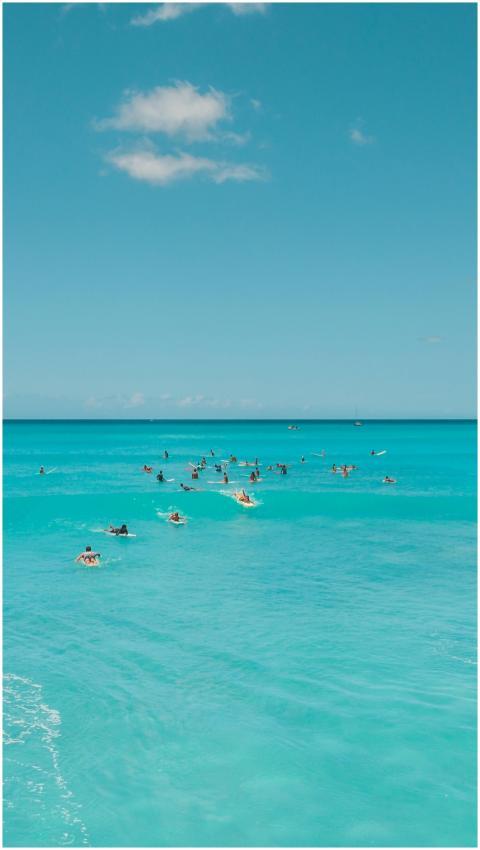 A vibrant scene of surfers enjoying the ocean unde