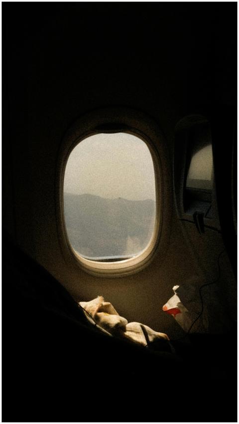 Airplane window view showcasing scenic mountains a