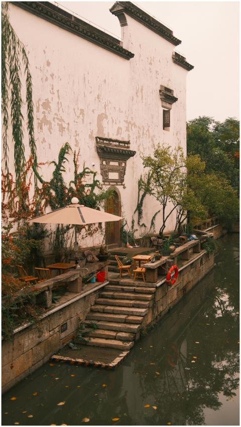 A quiet canal-side cafe with outdoor seating besid