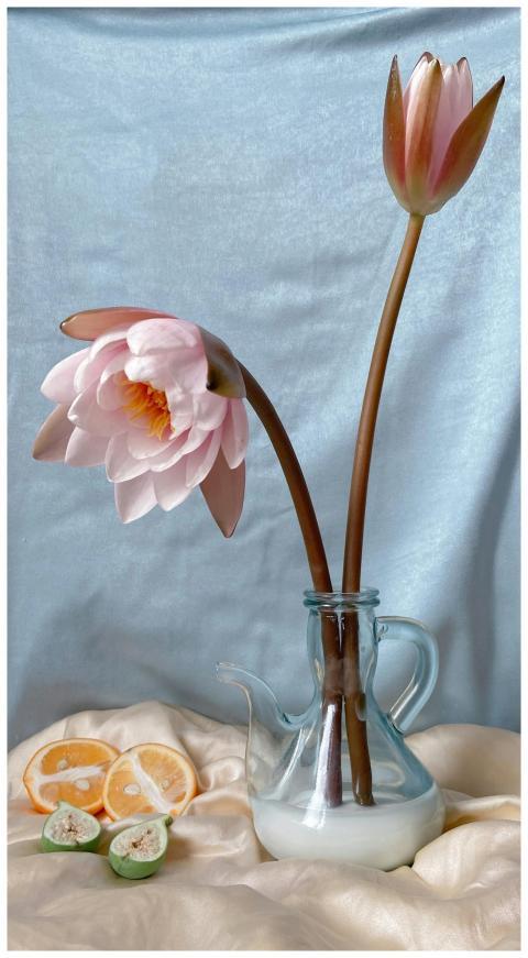Composition of glass pitcher with delicate flowers