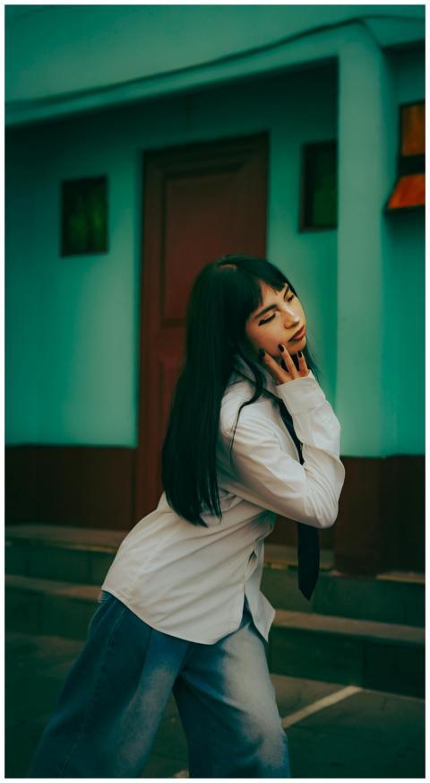 Young woman posing outdoors in a fashionable outfi