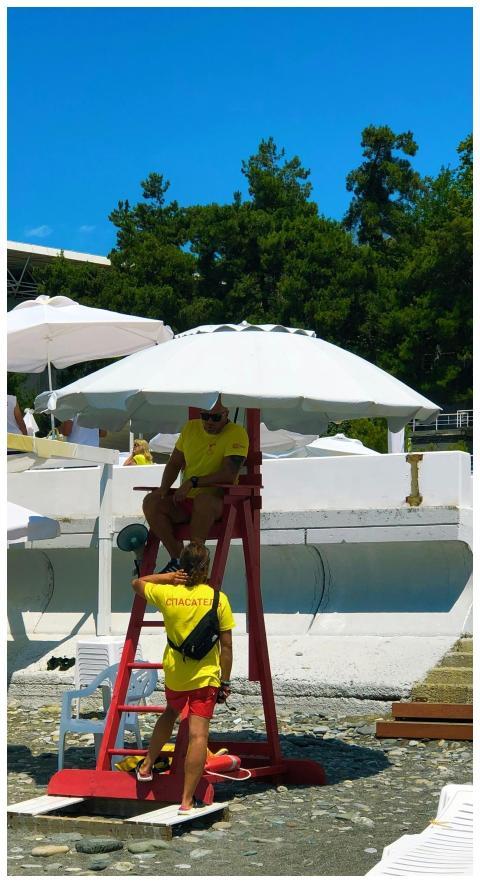 Lifeguards in bright uniforms overseeing safety on