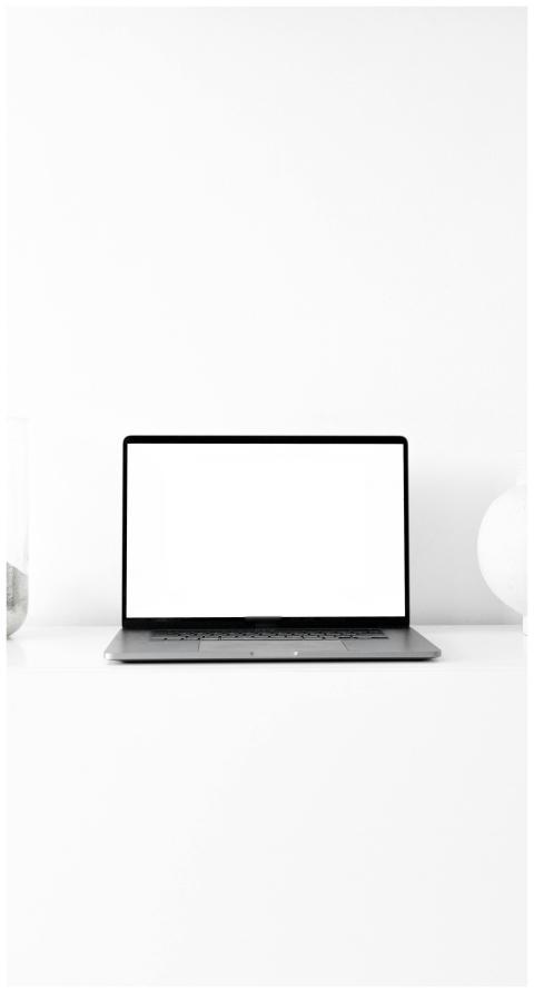 A sleek laptop with blank screen in a minimalist s