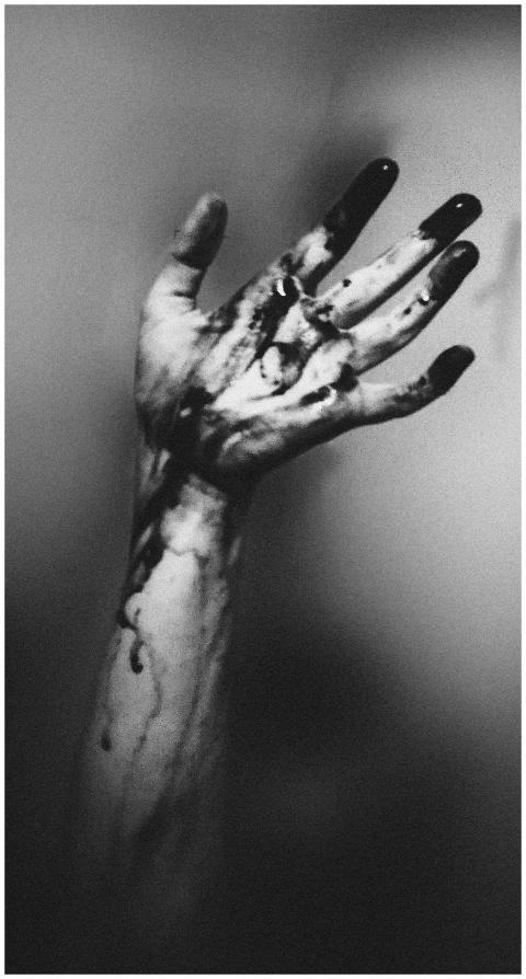 A monochrome image of an outstretched hand with da