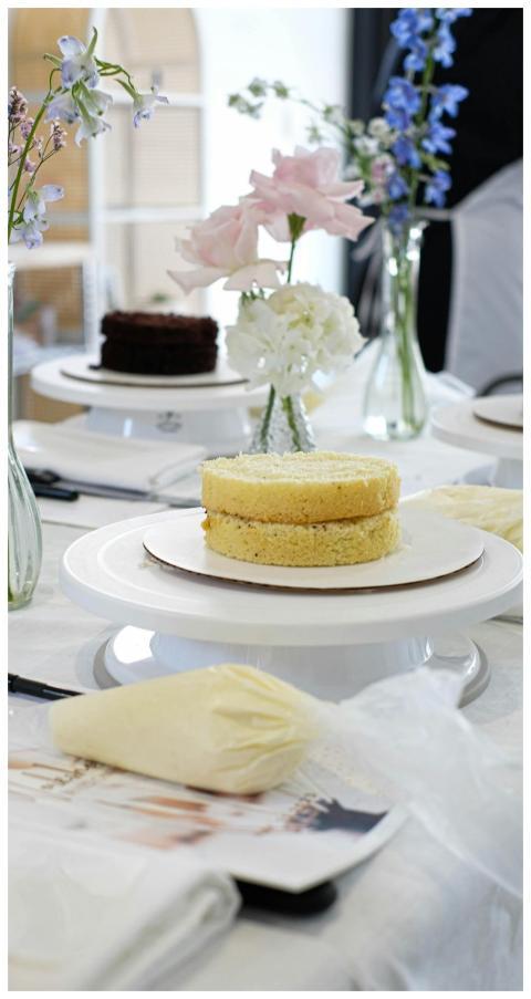 A beautifully set table with cakes and flowers rea