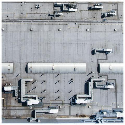 Aerial top view of a factory roof showcasing indus
