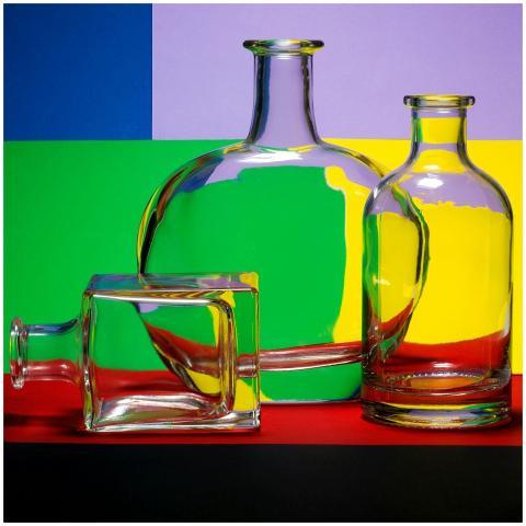 Glass bottles with a colorful geometric background