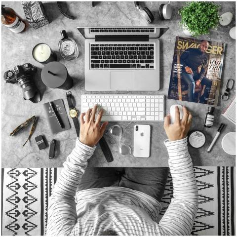 Overhead view of an organized desk with tech gadge