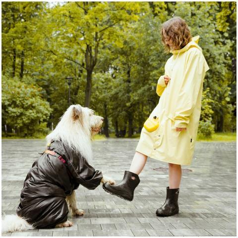 Woman and dog in matching raincoats sharing a mome