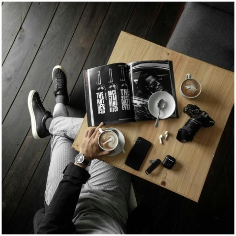 A stylish overhead view of a man enjoying coffee w