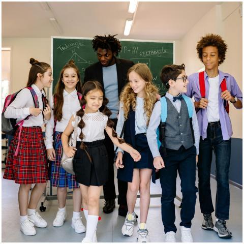 Group of schoolchildren with their teacher walking