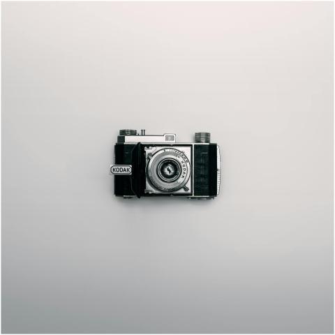 A classic Kodak camera displayed centrally on a mi