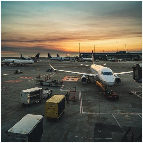 Airplanes parked at a busy airport terminal during