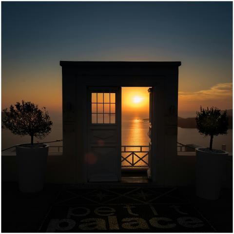 Stunning sunset view through a doorway in Santorin