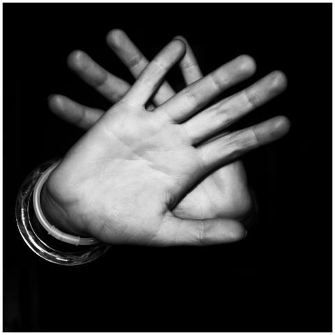 Monochrome close-up of hands in stop gesture again