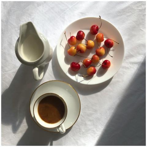 Top view of ripe sweet cherries on plate placed on