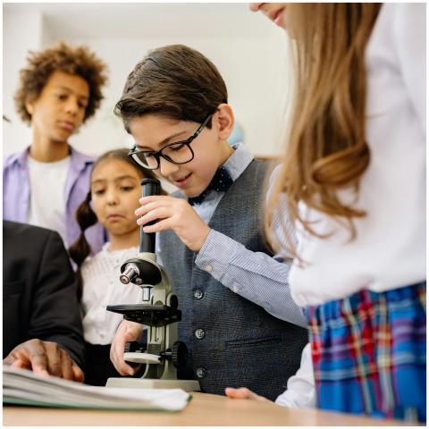 Children in a classroom exploring science with a m