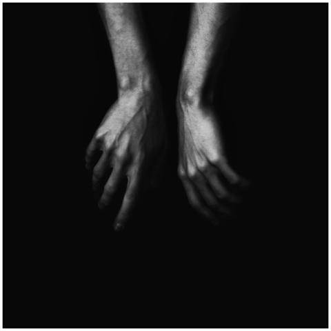 Dramatic black and white photo of a man's hands sh